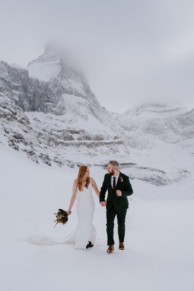Married couple celebrating their elopement on top of a mountain
