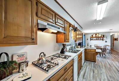 Open kitchen with views of the dining area and living room in this 3-bedroom, 2.5 bathroom rural vacation rental house just minutes outside of downtown Waco, TX.