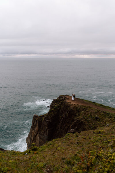 Couple dancing near the edge of a cliff on the Oregon Coast.