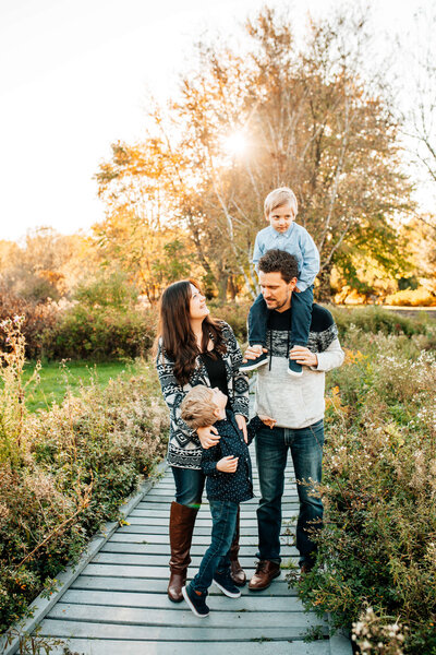 An energetic family is photographed by Chelsey Kae Photography at the University of Guelph Arboretum.