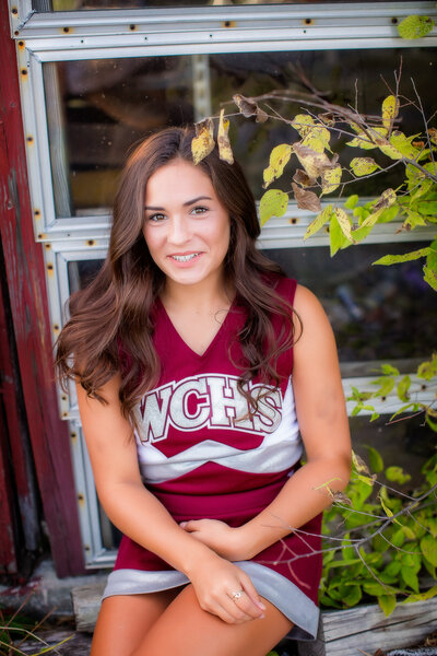 Color image of female in her cheerleading uniform smiling at camera