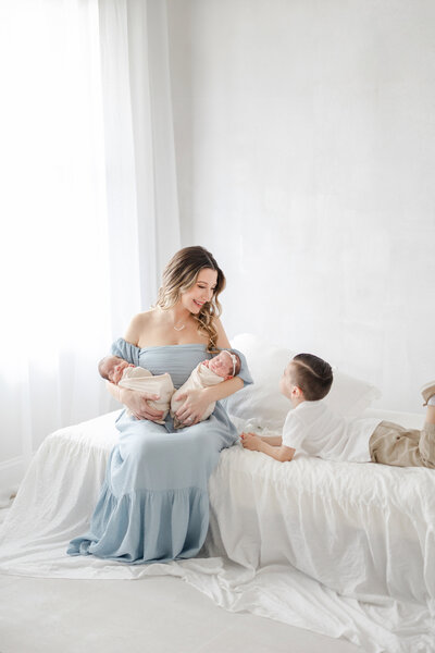 Luxury newborn portrait of Tampa twin baby swaddled in neutral tones