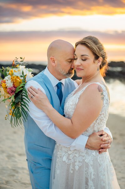 a tender moment between the bride and groom after their Hawaiian elopement