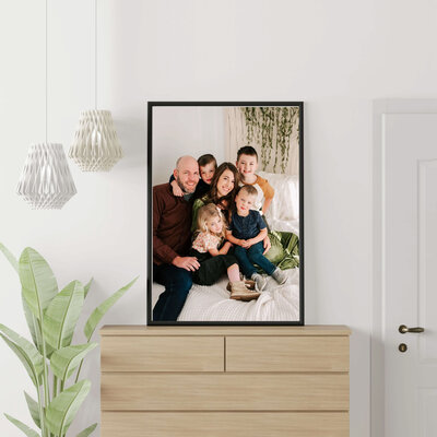 framed photo above dresser of family cuddling  in family photography studio in Branson