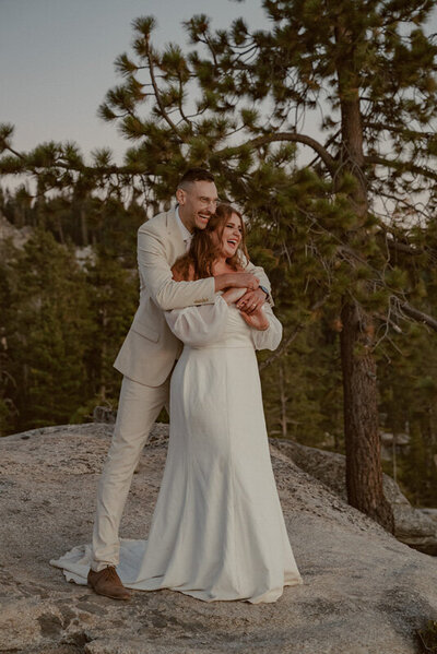 bride and groom laughing at their wedding at taft point in yosemite