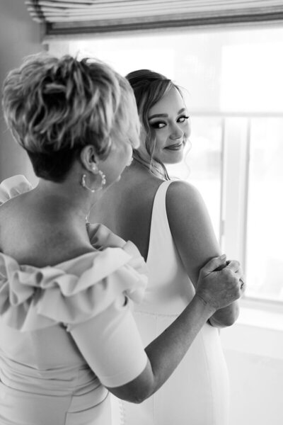 bride looking at mother of the bride on wedding day by south florida wedding photographers