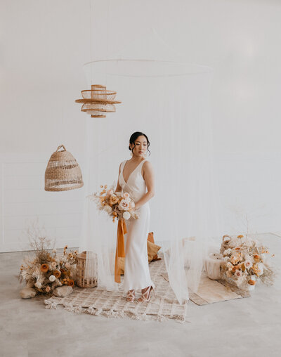 Indoor elopement inspiration with canopy tent at Tin Roof Event Centre, a modern wedding venue in Lacombe, Alberta, featured on the Brontë Bride Blog.