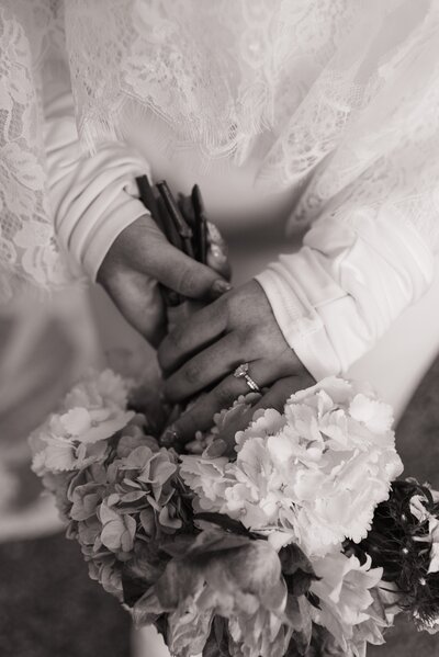 black and white closeup of bride holding her bouquet