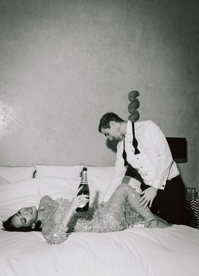 Couple Laying in Bed with Champagne