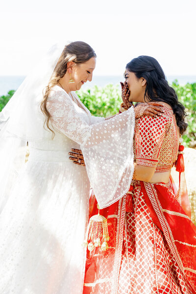 A newlywed couple crying during their first look 