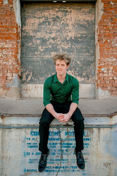 senior boy sitting on steps at the courthouse in santa barbara california