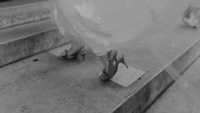 Bride and groom at Calton Hill in Edinburgh sharing a quiet moment beneath the Dugald Stewart Monument during their wedding photoshoot.