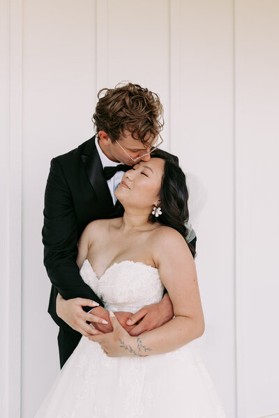 A groom giving his bride a kiss during their bridal portraits at the terrance in upstate south carolina 