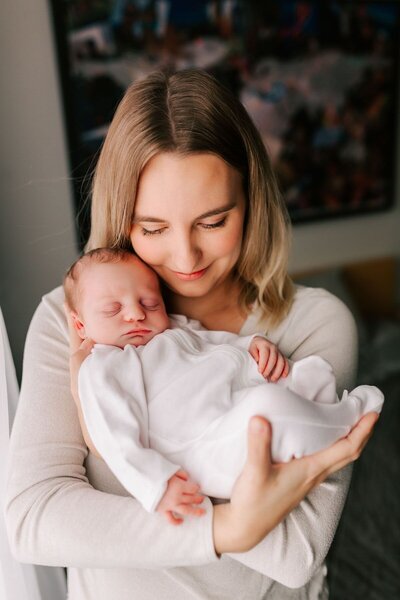 momma holding newborn baby wearing jewlery
