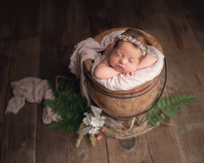 Newborn baby girl in studio bucket prop Southern Oregon studio