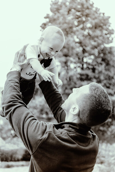 Father holding up a young child