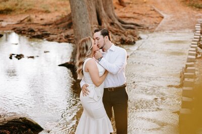 Photo of engaged couple at natural park kissing in Texas photographed by Lois M Photography