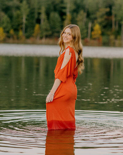Senior sits on path at JMU Arboretum