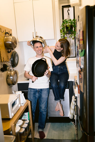 a couple standing in a new york city apartment kitchen