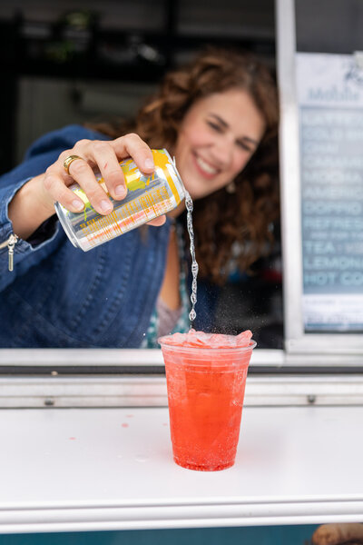 Rachel pouring a fruit flavored refresher beverage