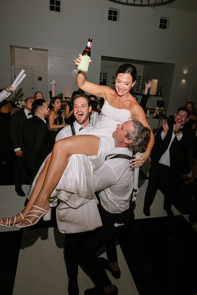 Flash photo of bride dancing in a short white dress