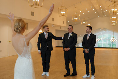 the bride has a first look with her dad and brothers on her wedding day at the eloise in mount horeb wisconsin