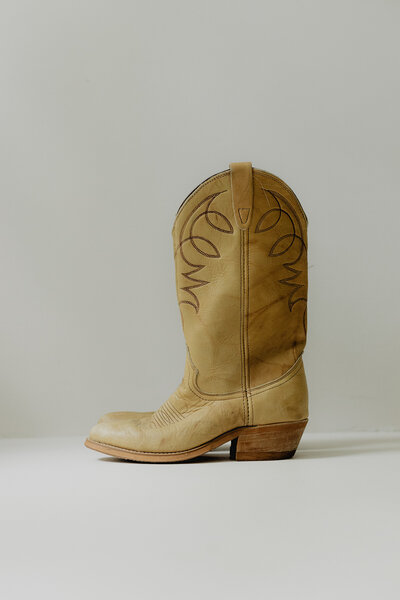 vintage yellow cowboy boot on a white backdrop