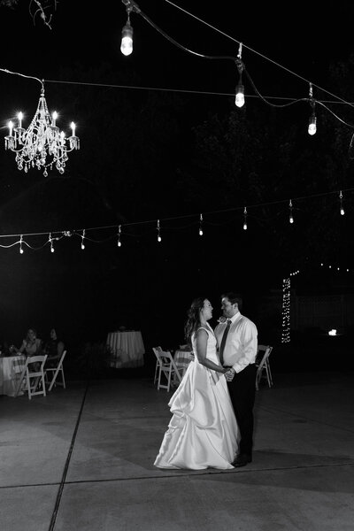 bride and groom slow dance during their first dance during their wedding reception at