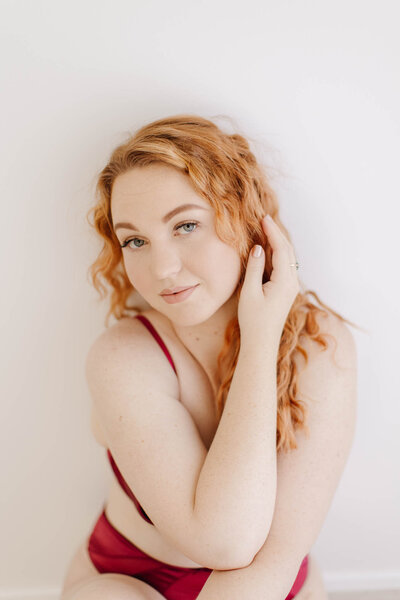 sensual boudoir portrait with read hair and ruby lingerie