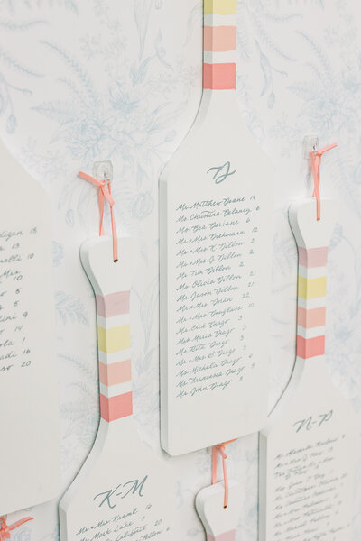 White canoe paddle seating chart with grey  calligraphy for  Canoe Place wedding in Hampton Bays, New York