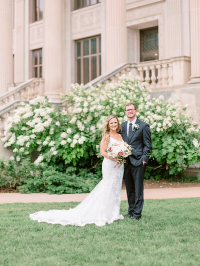 Bride and groom on their wedding day smiling at camera