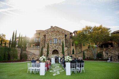 Outdoor wedding in front of stone building