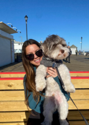 Wahls Protocol Success Stories Lori sitting on a bench with her dog