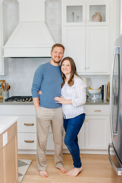 Jessie and Adam hugging in the kitchen of their home