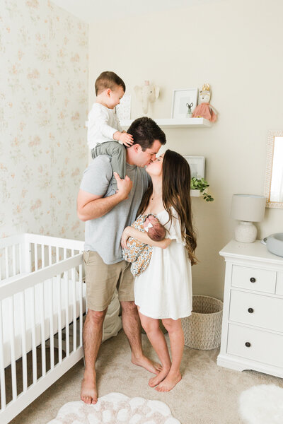 family together in newborn baby's nursery in lifestyle photos