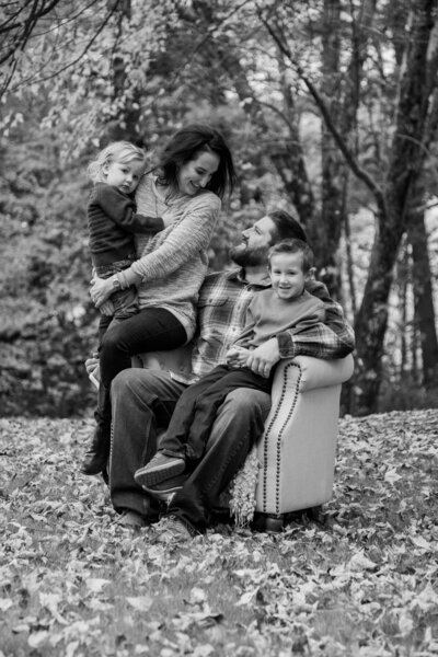 Family together, dad and son sitting in chair with trees in back | Family Photography by Storybook Photography By Heidi
