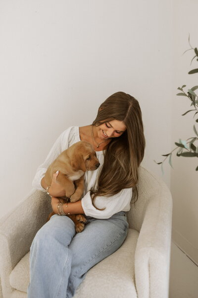 Girl holding labrador puppy