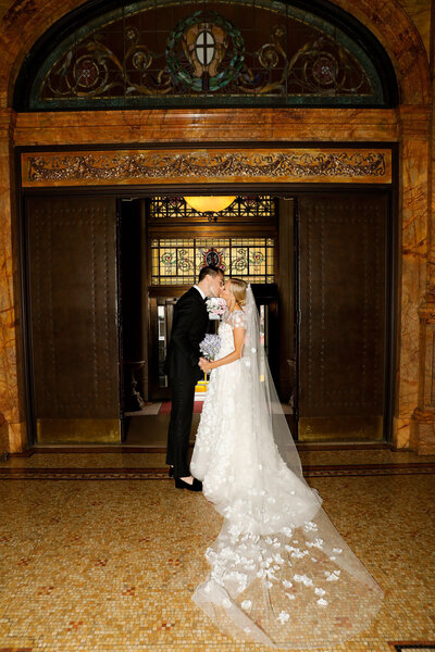 Bride and groom walking across a lawn together