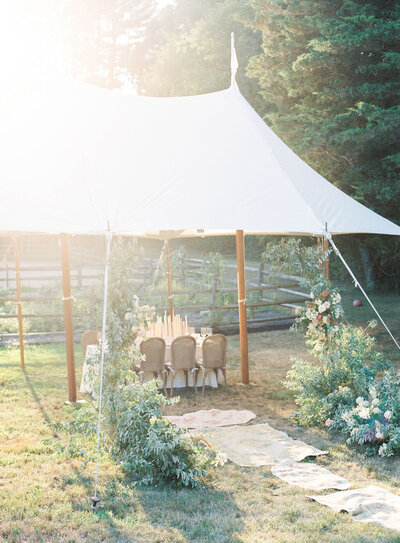 small wedding tent with a single table under it, pressumably for the bride and groom