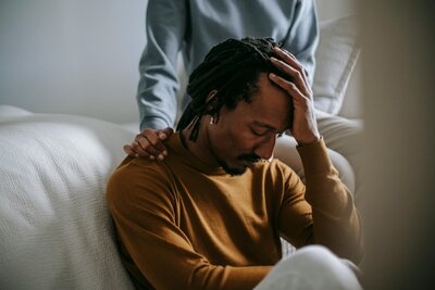 man holding head in palm