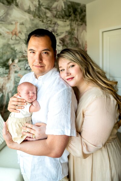 mom and dad holding a newborn in Maryland