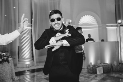 Groom dancing with sunglasses at wedding designed by brooklyn wedding planners at Helena Elizabeth Events