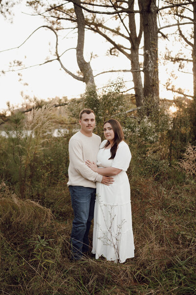 Groom leaning over bride smiling with a flowy veil
