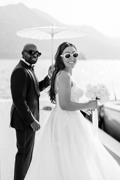 Bride and groom laughing by the water during their Montenegro wedding, captured in timeless black and white by Toronto destination wedding photographer