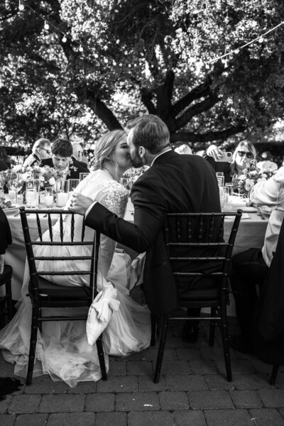 black and white timeless photo of bride and groom kissing at sonoma golf club wedding reception by milou and olin photography