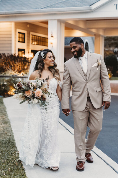 Boho-inspired bouquet with pampas grass, muted roses, and greenery by Leigh Florist, perfect for a trendy outdoor wedding.