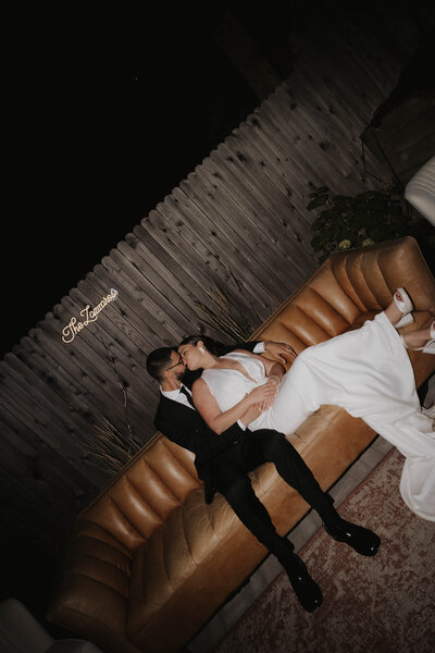 flash wedding photography of the bride and groom on a couch together