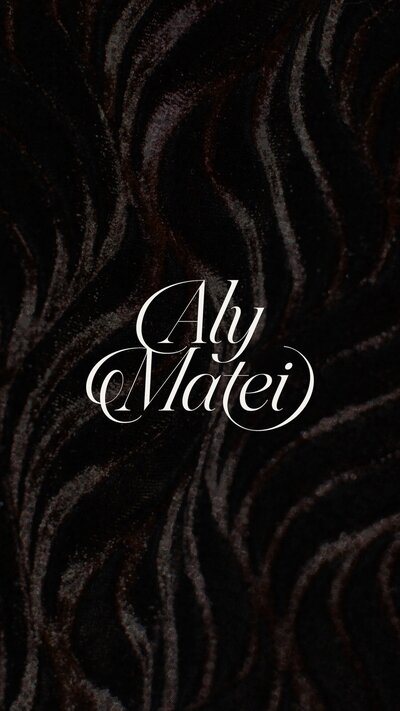 Aly Matei logo on a black textured background