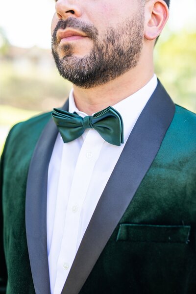 Emerald green groom velvet tuxedo at Hummingbird Nest Ranch Estate in Santa Susana, California.