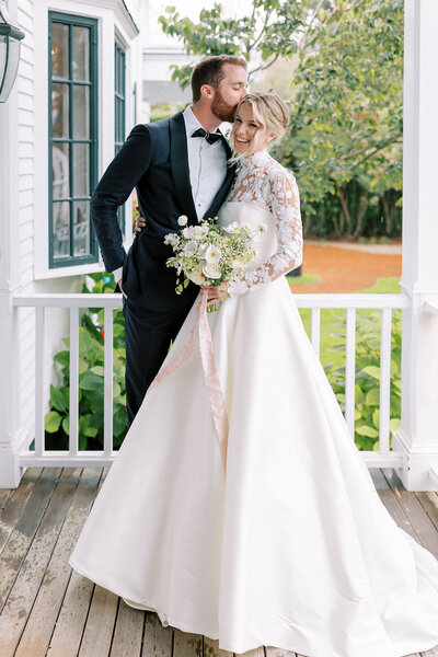 Wedding couple embracing on the porch after ceremony